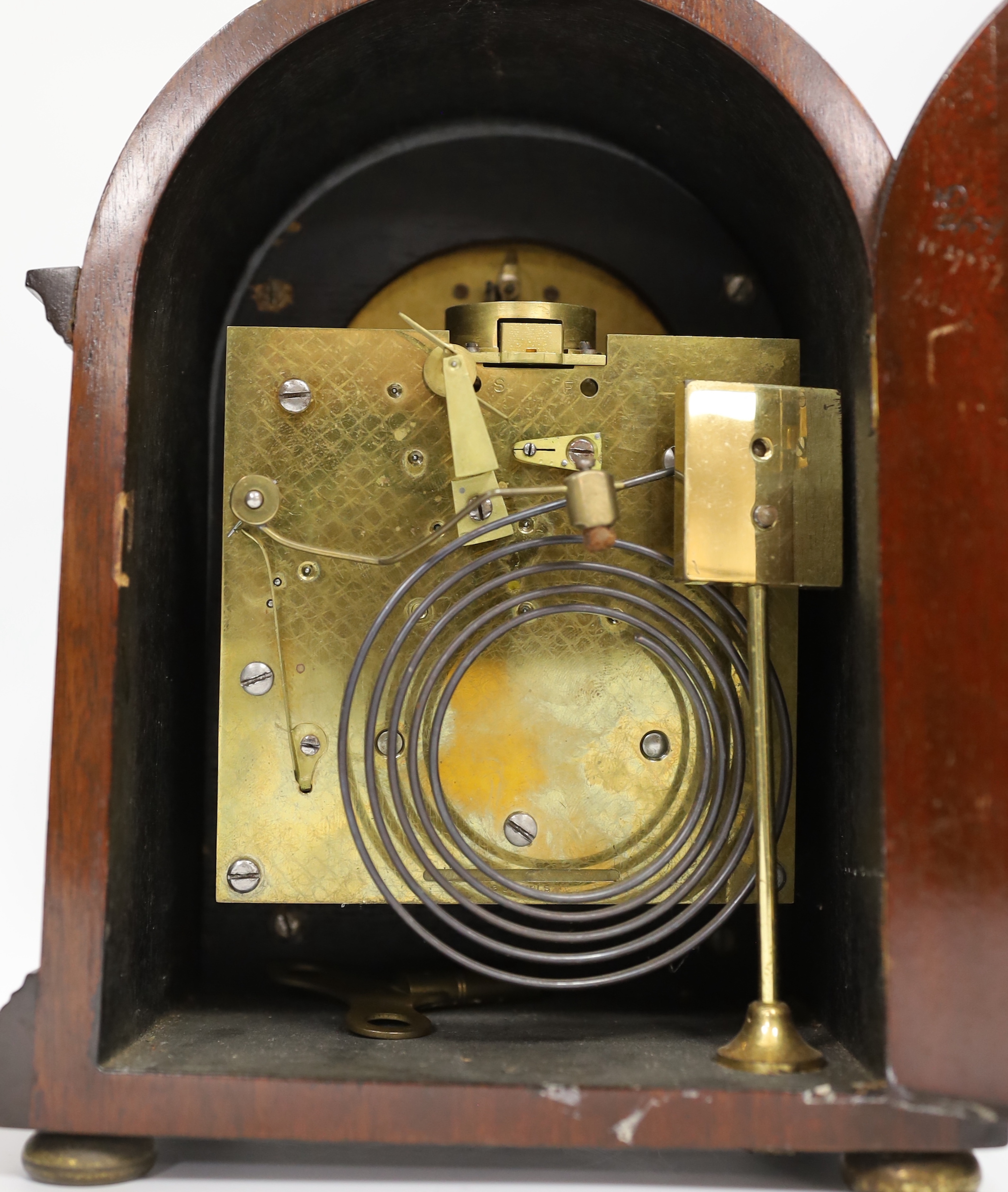 A mahogany mantel clock with silvered Roman numeral dial, 23cm high